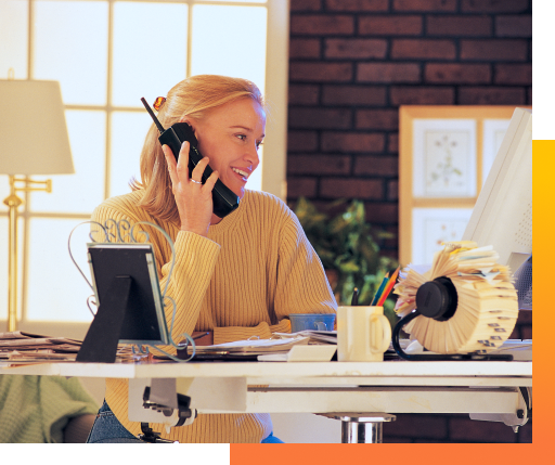 person on the phone looking at computer